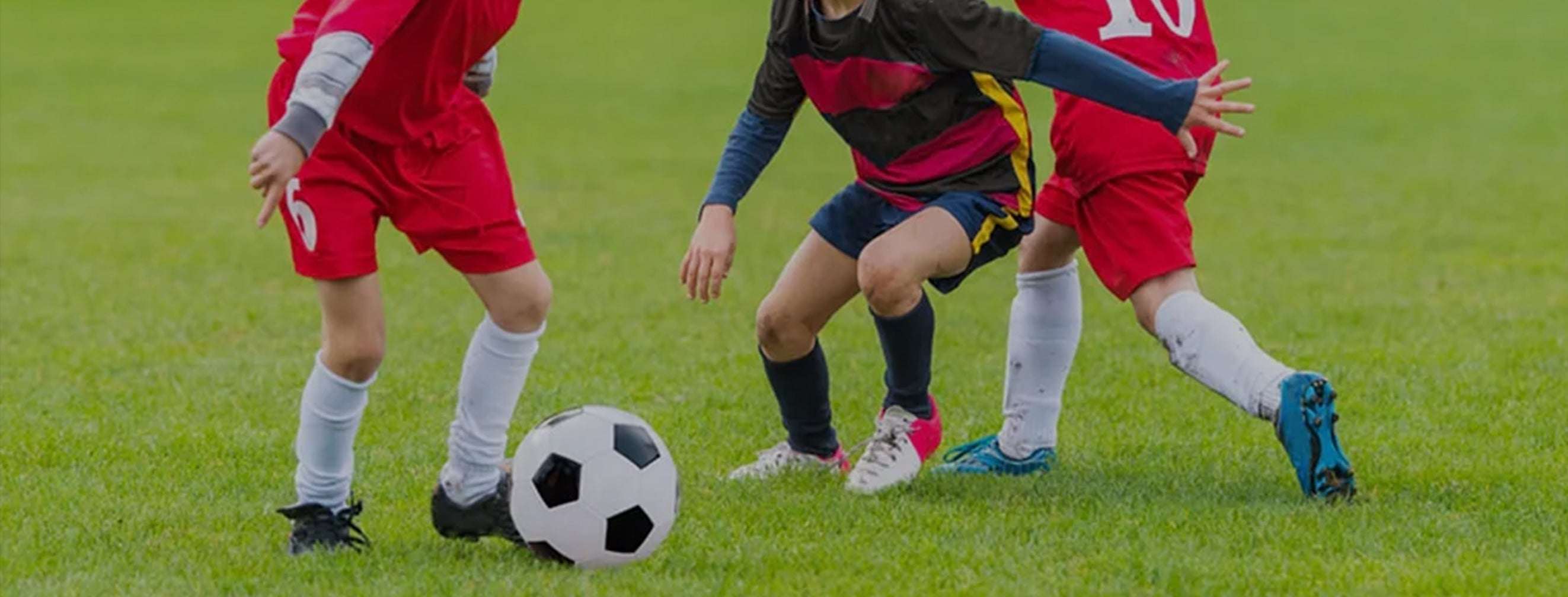 Children playing soccer on a grass field1621243260e1af0c20-0